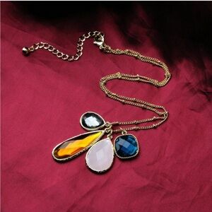Rhinestone multicolor teardrop necklace on gold alloy chain.